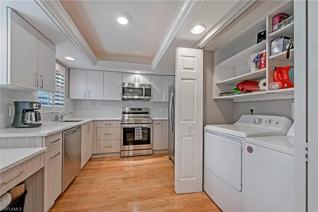 a kitchen with kitchen island sink stove and cabinets
