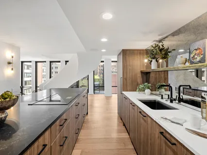 a kitchen with sink and refrigerator