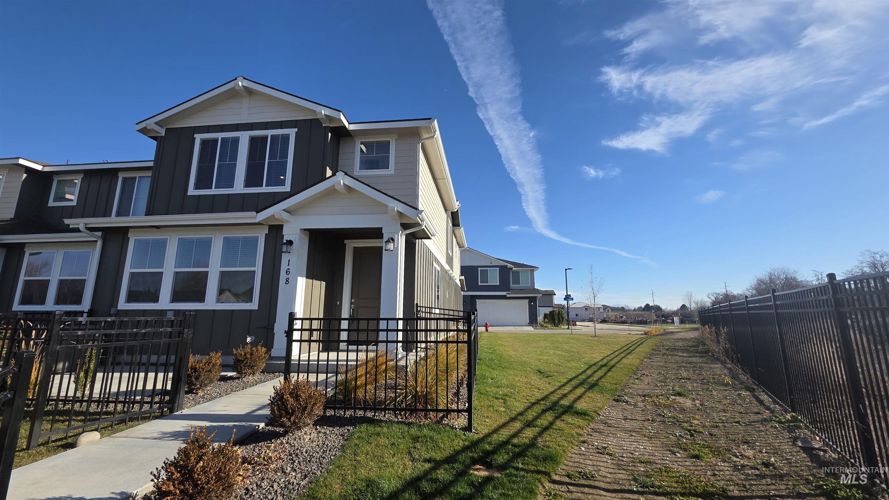 View of front of property with a fenced front yard and board and batten siding