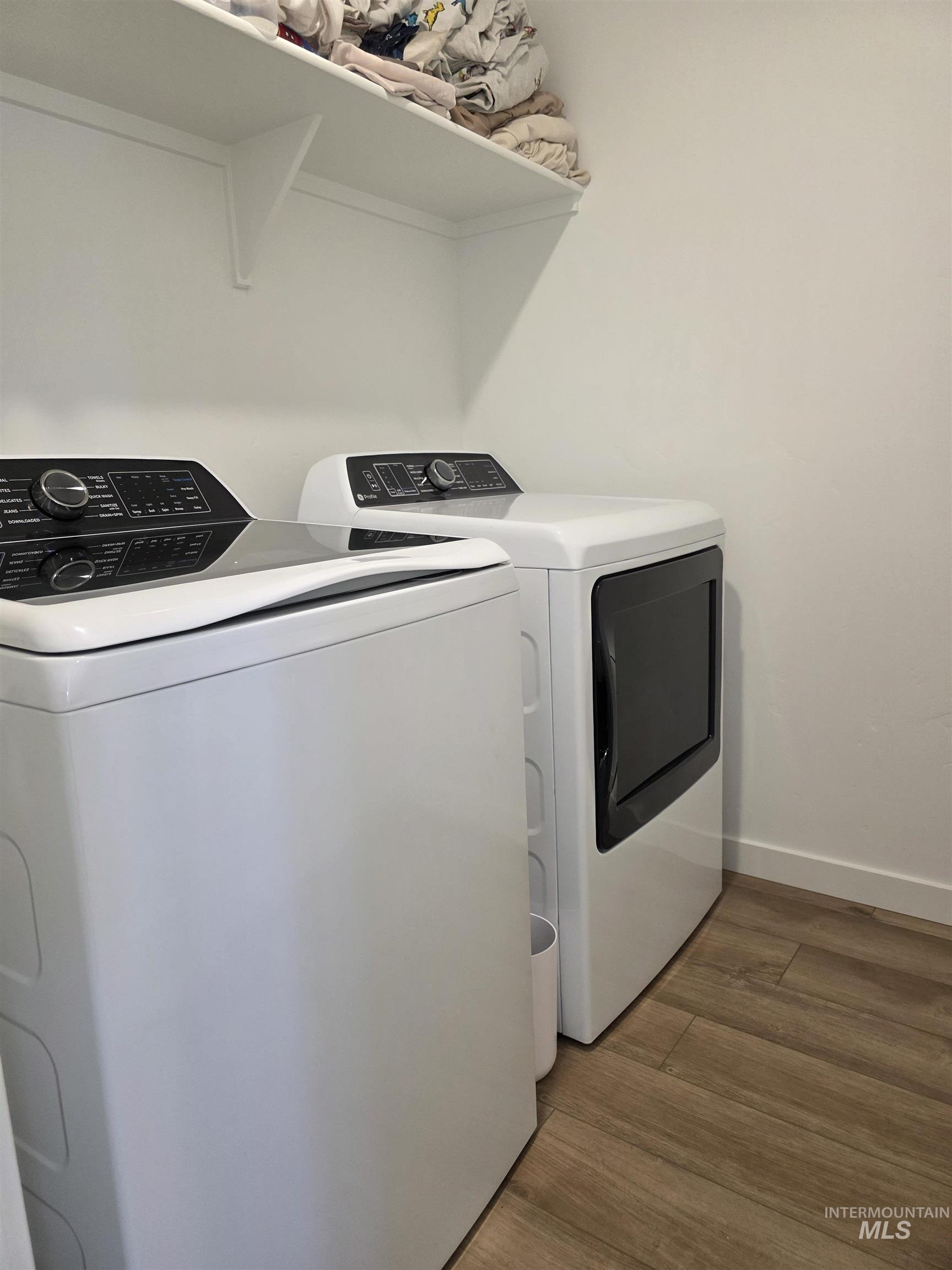 168 North Stratus Way Eagle, ID 83616 - Photo 25 of 35 Laundry area featuring wood finished floors and washing machine and clothes dryer
