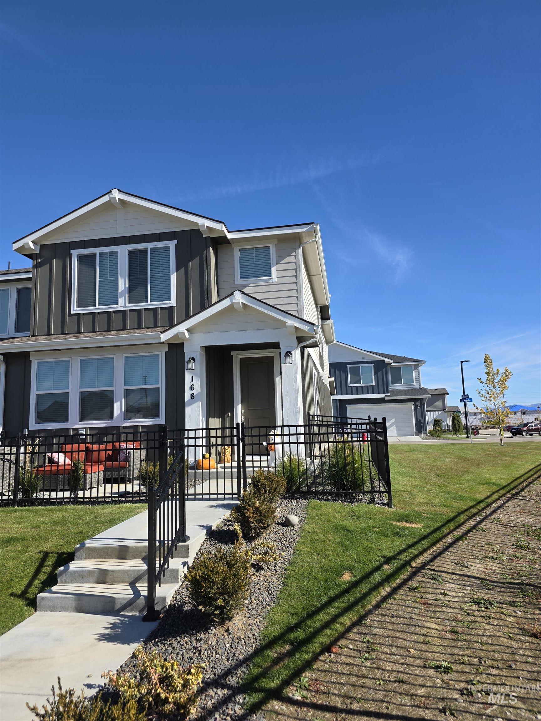 168 North Stratus Way Eagle, ID 83616 - Photo 27 of 35 View of front of house featuring a fenced front yard, board and batten siding, and covered porch