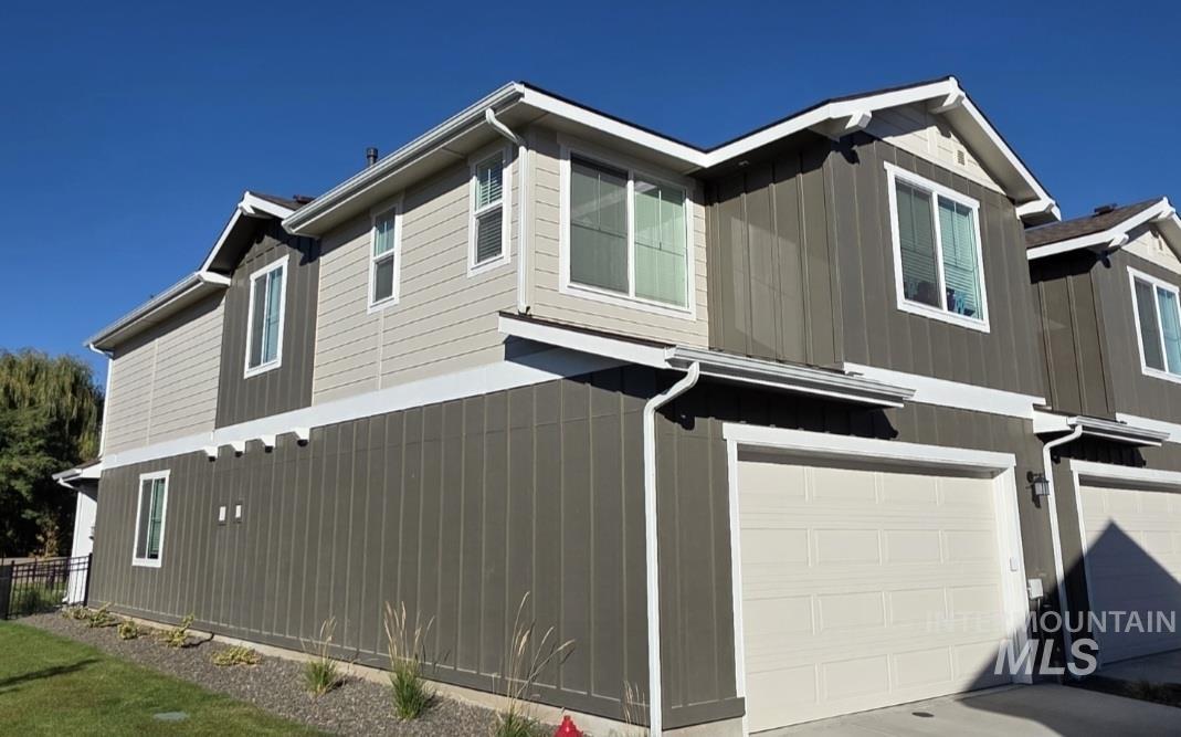 168 North Stratus Way Eagle, ID 83616 - Photo 3 of 35 View of side of property with an attached garage, board and batten siding, and driveway
