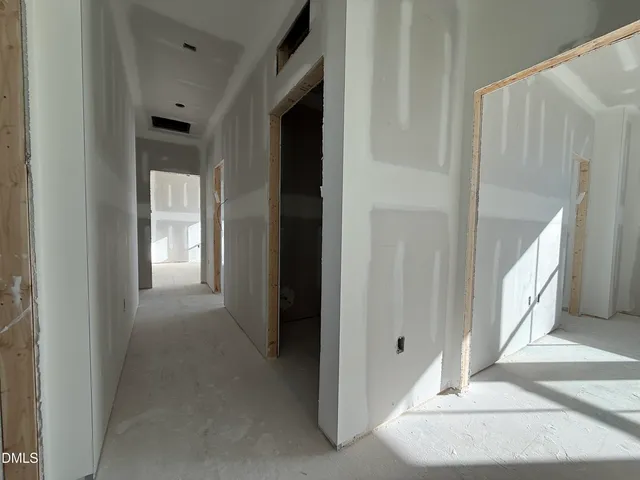 a view of a hallway with wooden floor and entryway
