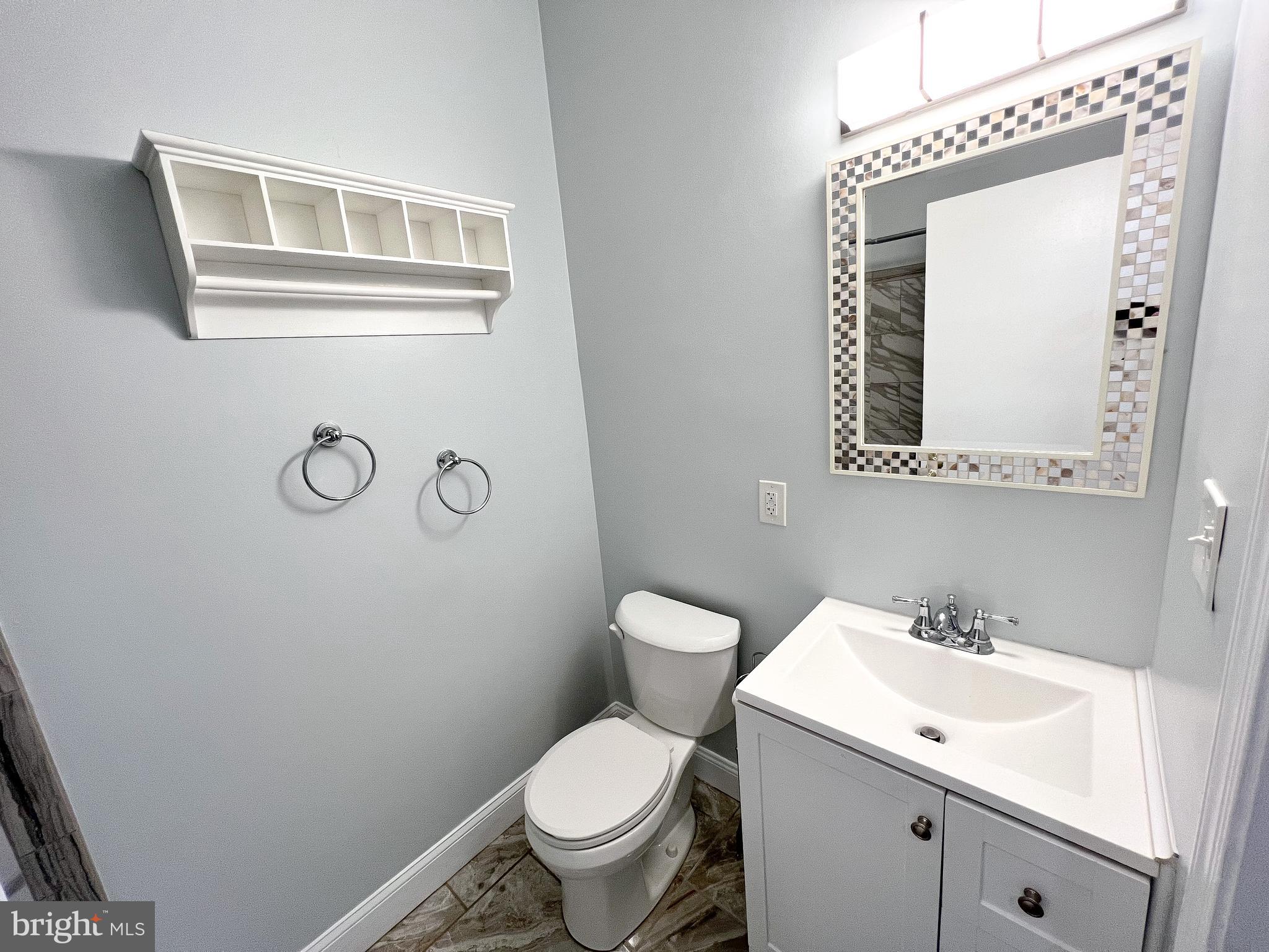 617 U Street Northwest Washington, DC 20001 - Photo 21 of 27 a bathroom with a toilet sink vanity and mirror
