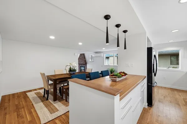 a view of a kitchen area with furniture and wooden floor