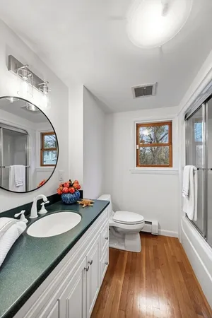 a bathroom with a sink vanity granite and a mirror