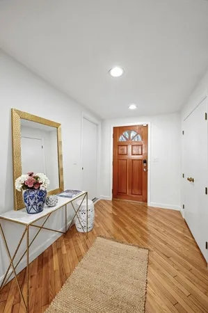 a view of a livingroom with wooden floor and cabinet