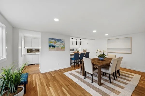 a view of a dining room with furniture and wooden floor