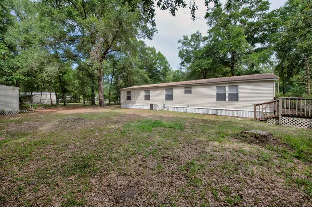 a view of a backyard with large trees