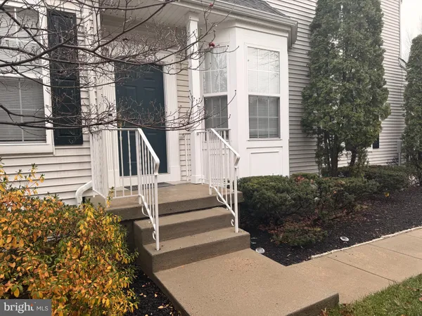 a view of a house with more windows and brick walls