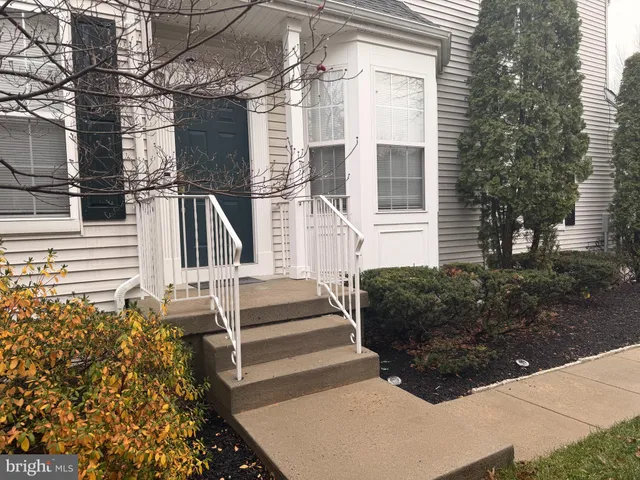 a view of a house with more windows and brick walls