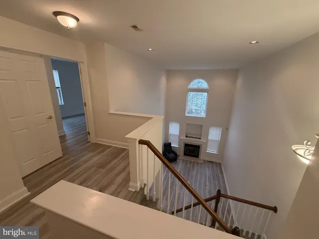 a view of stairs and hall with wooden floor