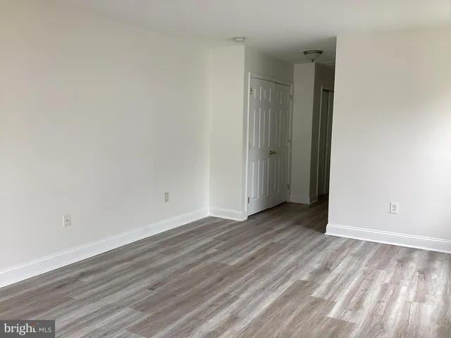 a view of an empty room and wooden floor