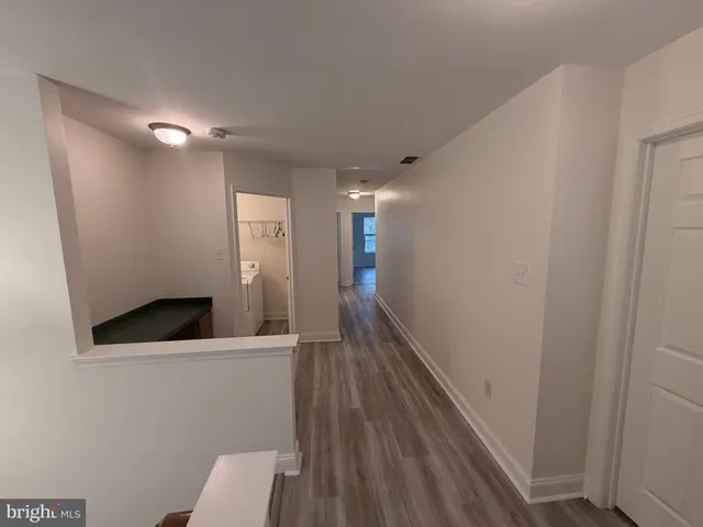 a view of hallway with wooden floor
