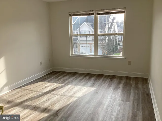 a view of a room with wooden floor and windows