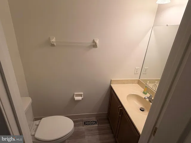 a bathroom with a sink a toilet a mirror and vanity