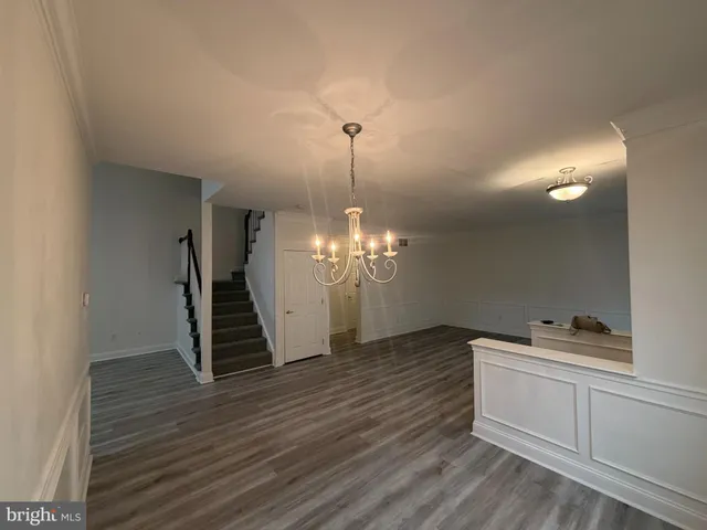 a view of a room with wooden floor and staircase