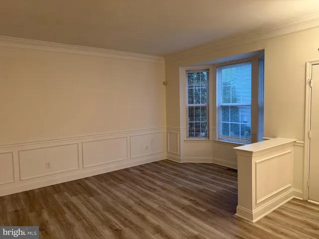 a view of a room with wooden floor and cabinet