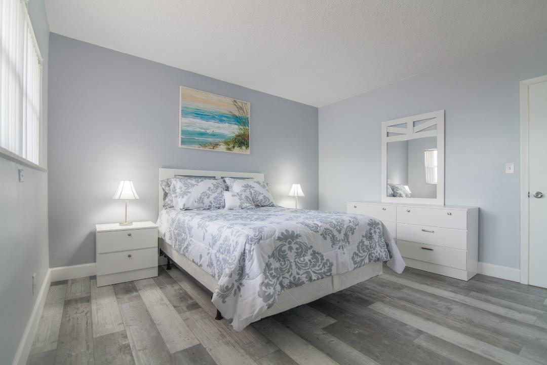 320 South Surf Road, Unit 205 Hollywood, FL 33019 - Photo 14 of 18 a bedroom with a bed and a table