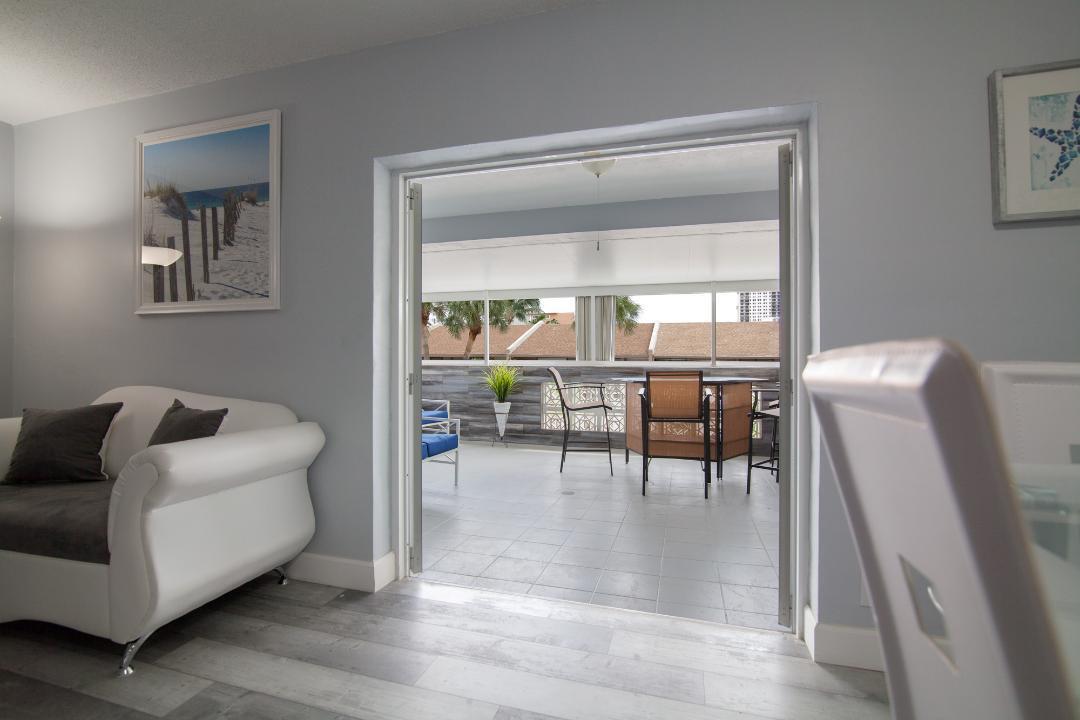 320 South Surf Road, Unit 205 Hollywood, FL 33019 - Photo 8 of 18 a living room with furniture and a window