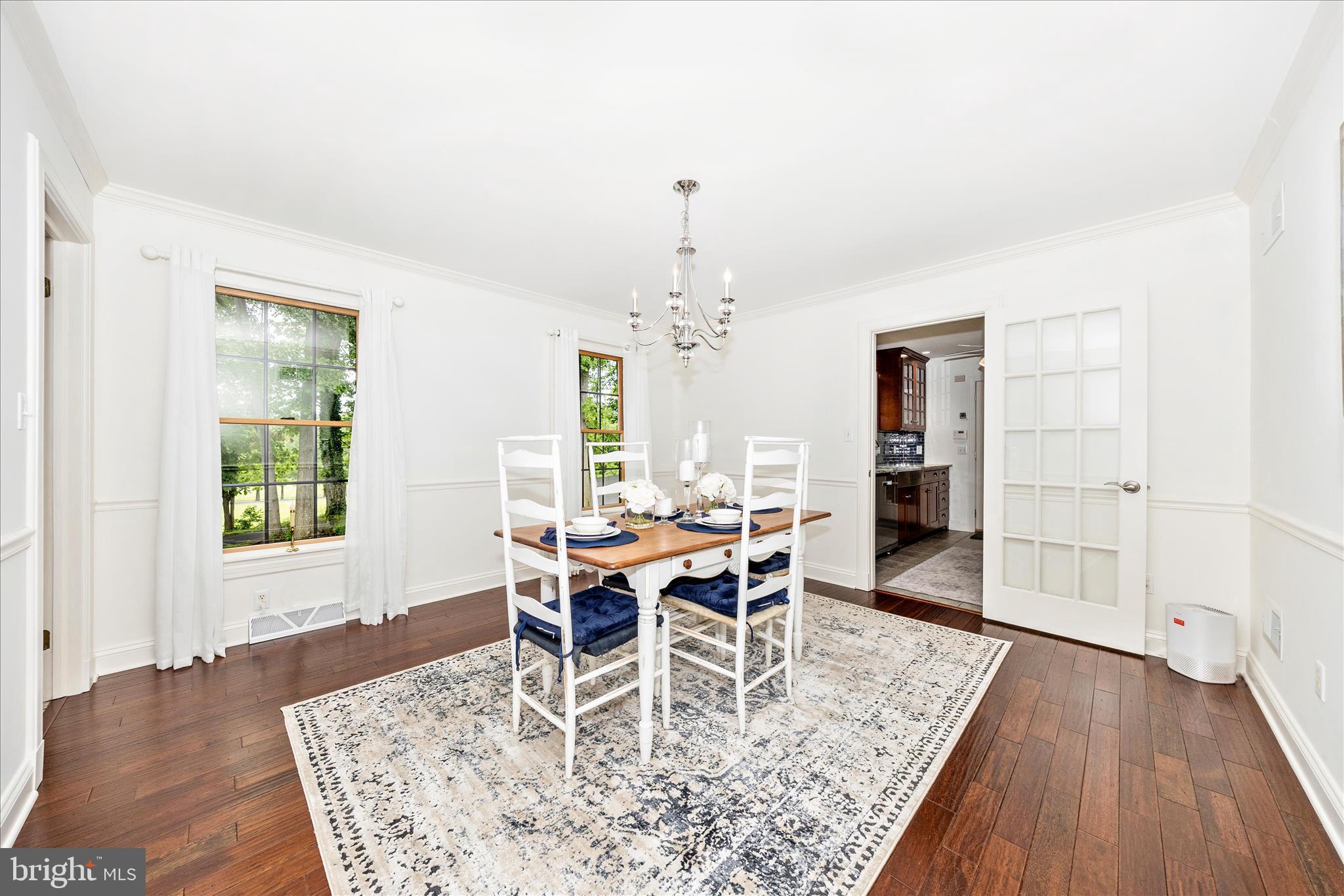 15810 Spade Road Hagerstown, MD 21740 - Photo 5 of 76 a dining room with wooden floor a chandelier a wooden table and chairs