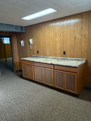 a kitchen with furniture a sink and a stove