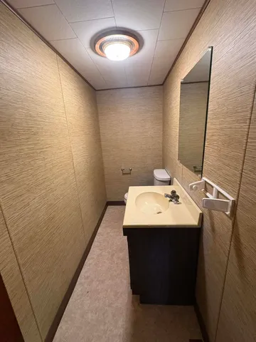 a kitchen with stainless steel appliances kitchen island granite countertop a refrigerator and a stove top oven