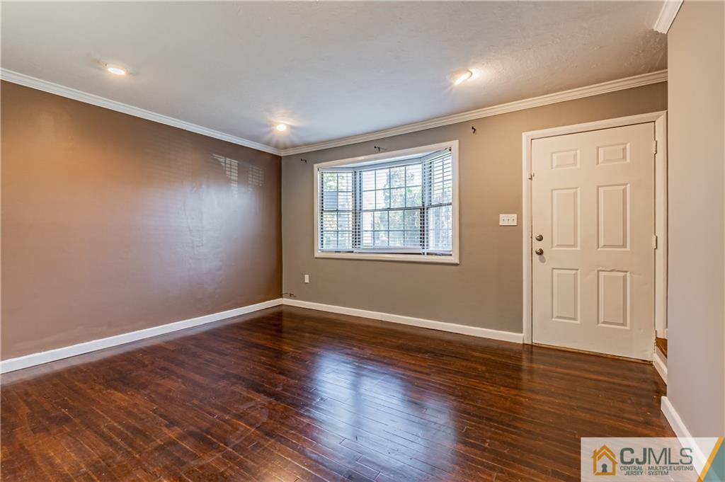 12 Jones Place Edison, NJ 08817 - Photo 13 of 28 a view of an empty room with wooden floor and a window