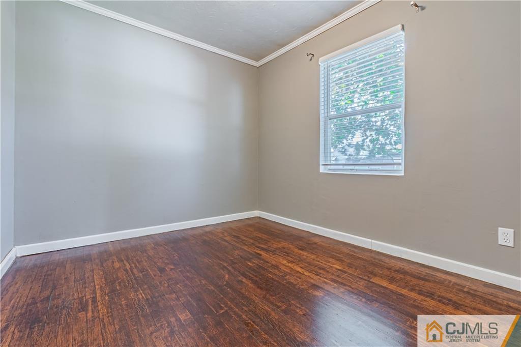 12 Jones Place Edison, NJ 08817 - Photo 17 of 28 an empty room with wooden floor and windows