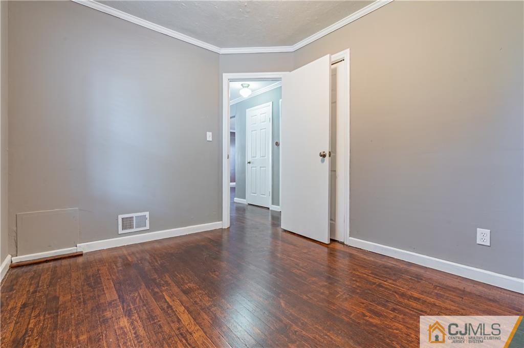 12 Jones Place Edison, NJ 08817 - Photo 18 of 28 a view of an empty room with wooden floor