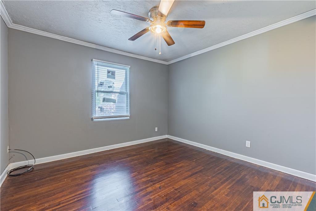 12 Jones Place Edison, NJ 08817 - Photo 19 of 28 a view of a room with wooden floor and a window