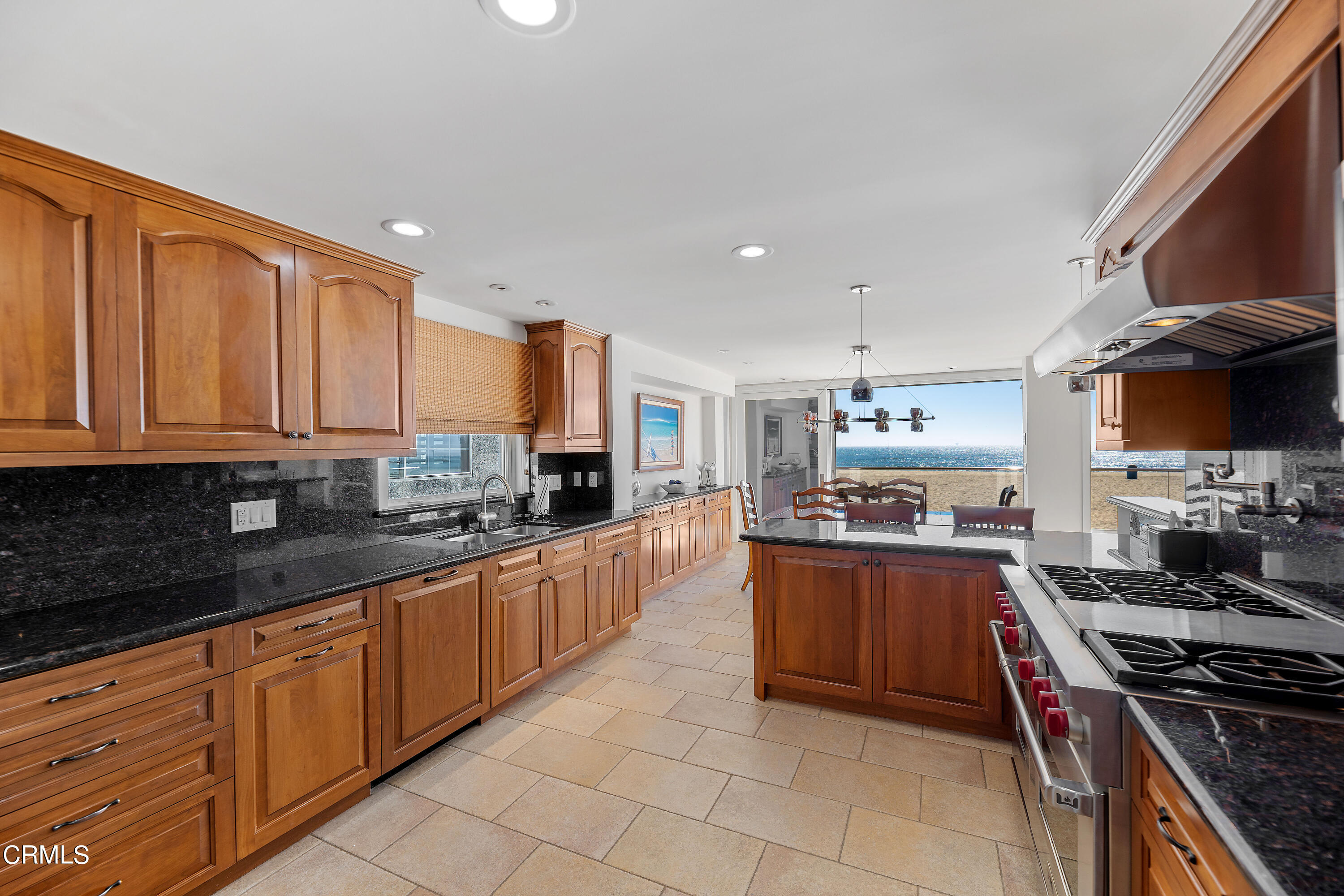 2013 Ocean Drive Oxnard, CA 93035 - Photo 24 of 60 a large kitchen with stainless steel appliances granite countertop a stove top oven a sink dishwasher and cabinets with wooden floor