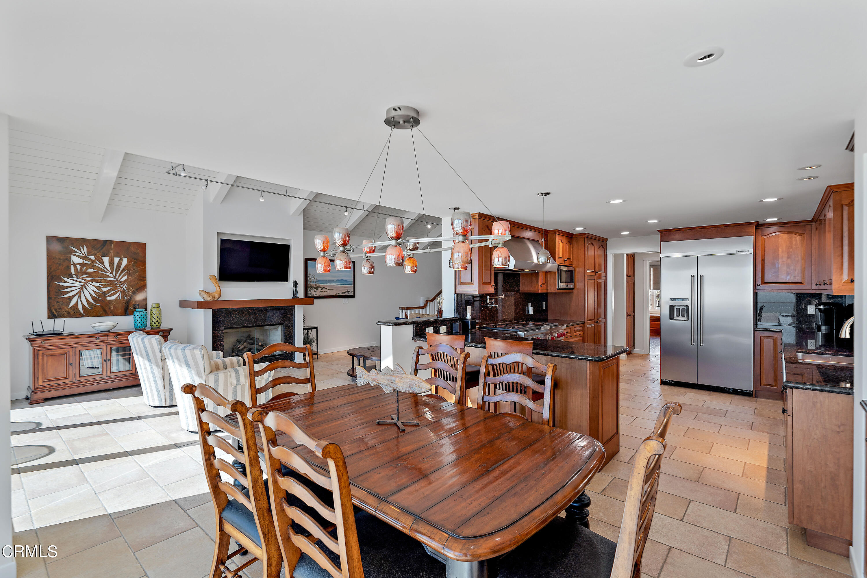 2013 Ocean Drive Oxnard, CA 93035 - Photo 27 of 60 a view of a dining room with furniture a kitchen and chandelier