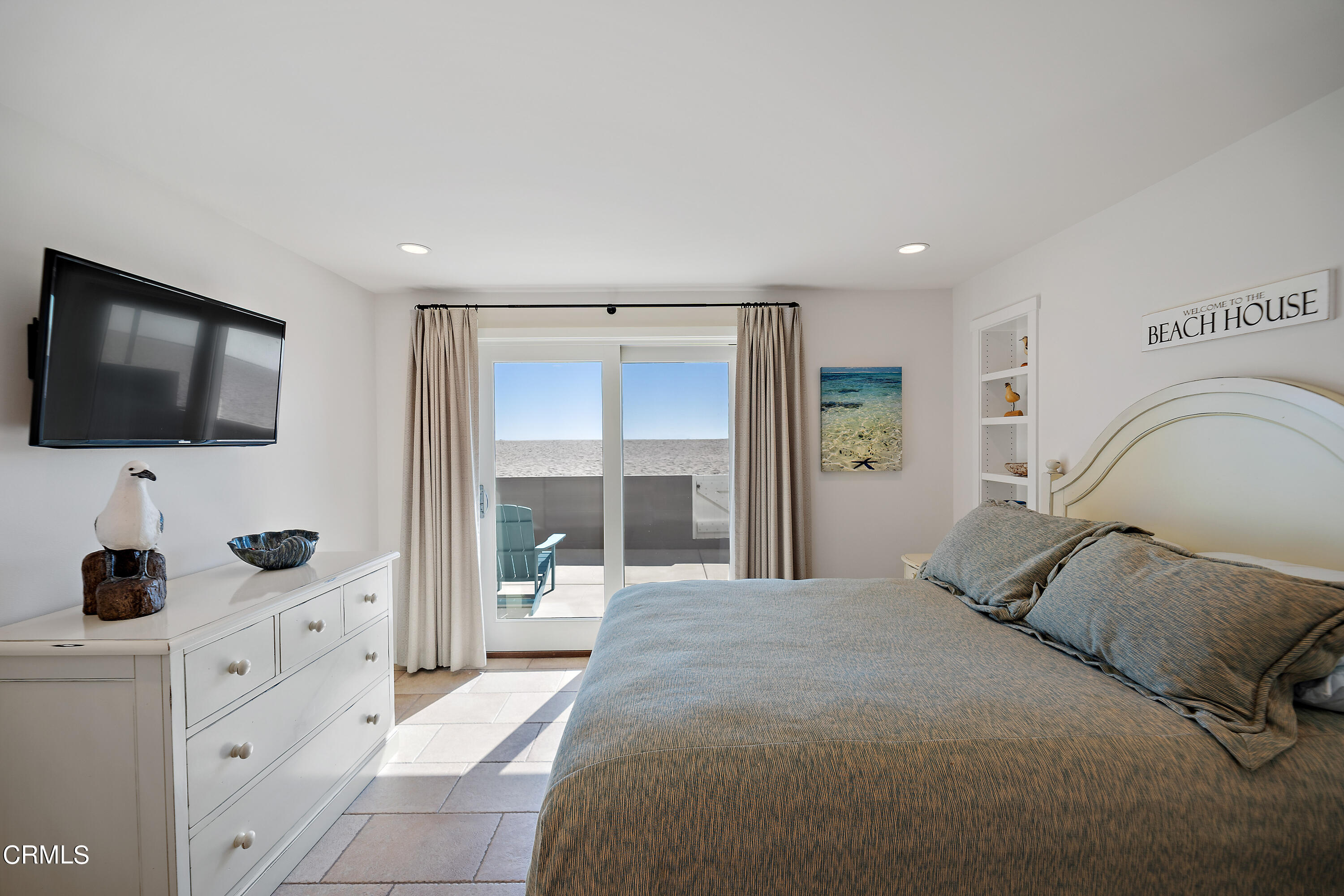 2013 Ocean Drive Oxnard, CA 93035 - Photo 54 of 60 a bedroom with a bed and a flat tv screen on the dresser