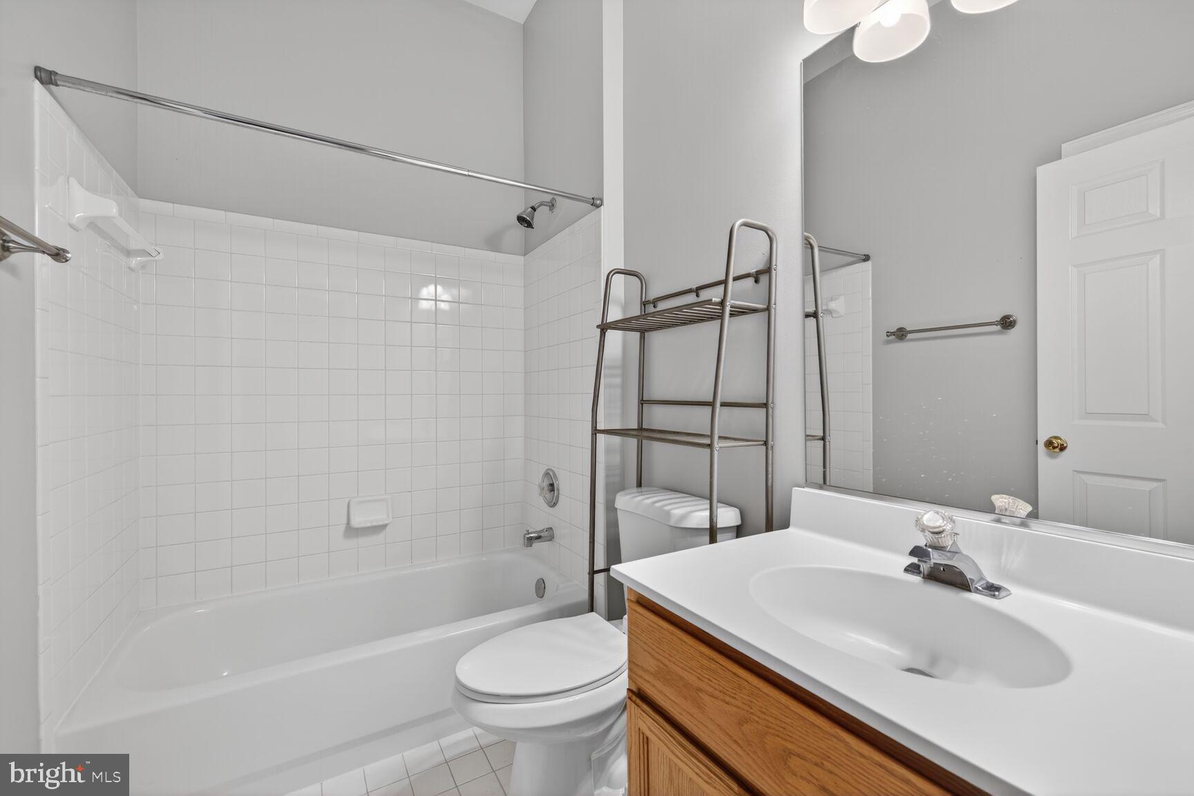 6715 Manorly Court Frederick, MD 21703 - Photo 11 of 15 a bathroom with a sink toilet and shower
