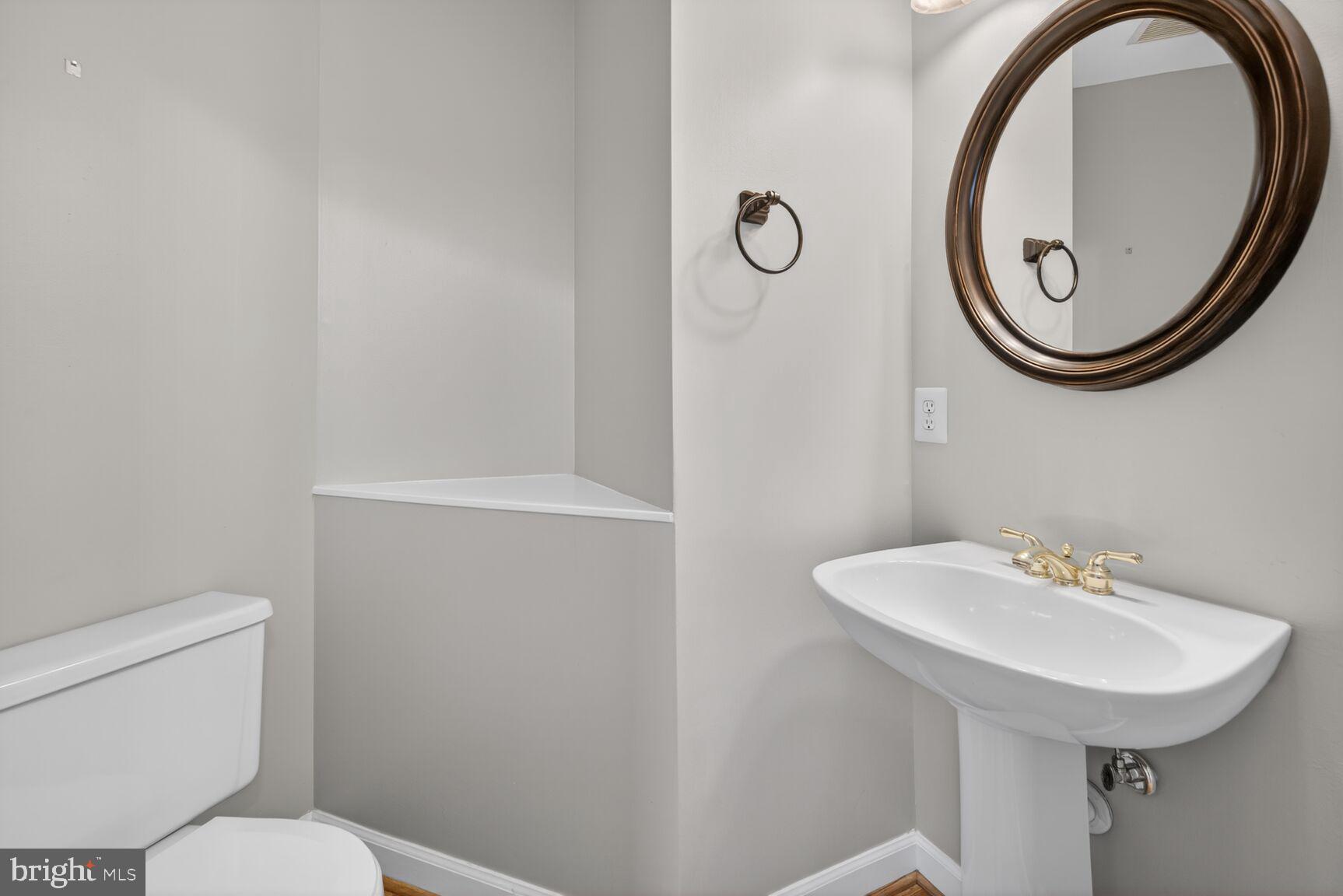 6715 Manorly Court Frederick, MD 21703 - Photo 12 of 15 a bathroom with a sink and a mirror