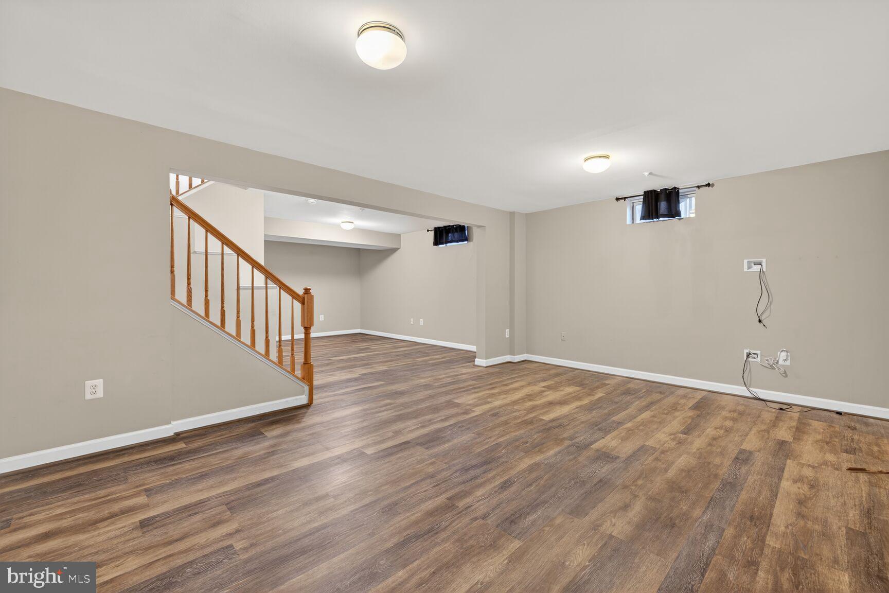 6715 Manorly Court Frederick, MD 21703 - Photo 13 of 15 a view of an empty room with wooden floor and a window