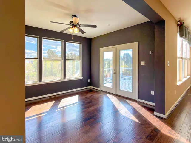 a kitchen with kitchen island granite countertop wooden cabinets and a refrigerator