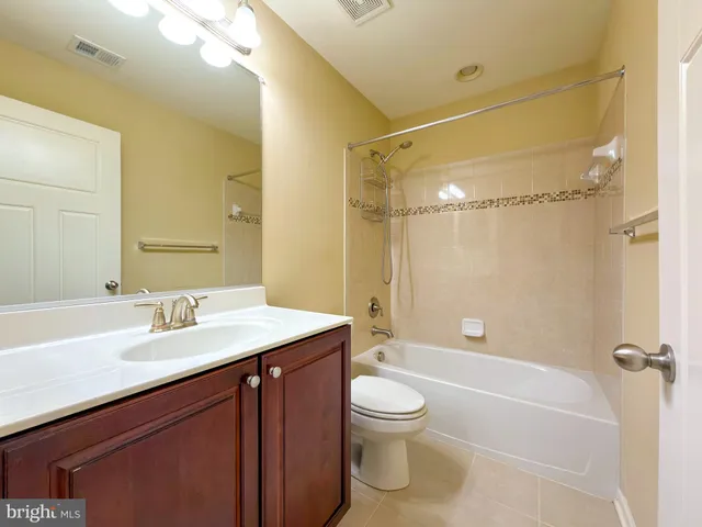a white toilet sitting next to a shower