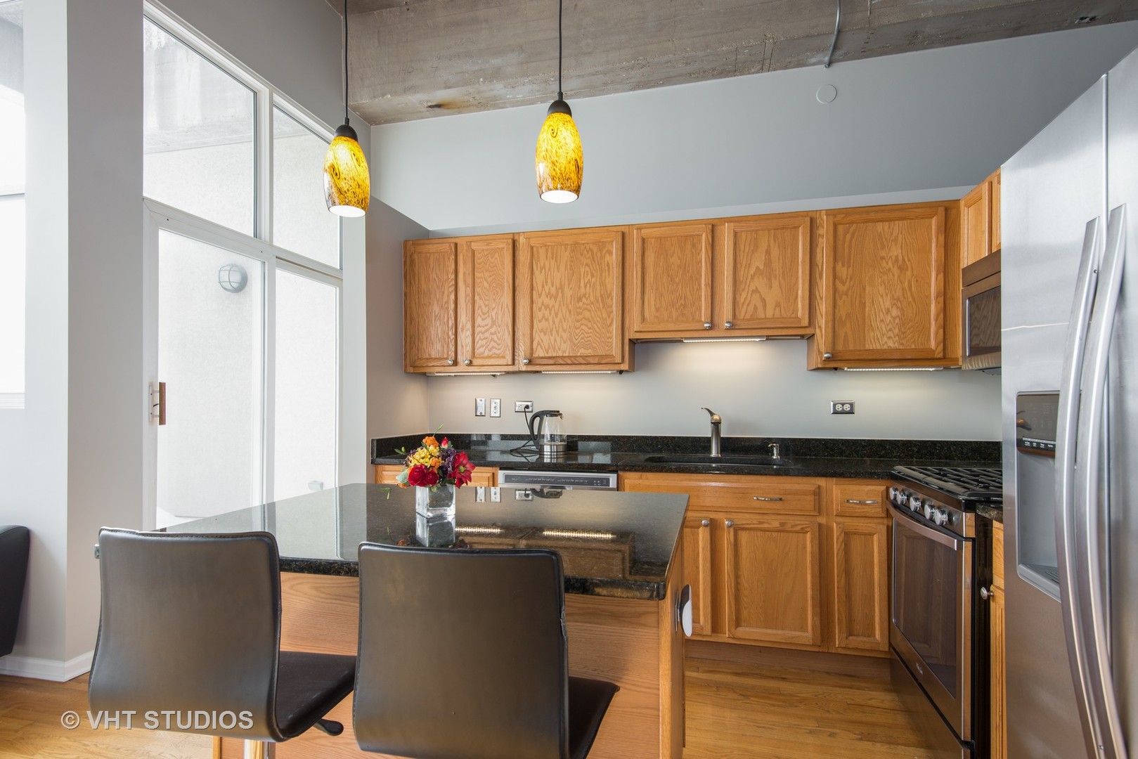 1834 Ridge Avenue, Unit 128 Evanston, IL 60201 - Photo 5 of 9 a kitchen with stainless steel appliances granite countertop a sink a stove and a refrigerator