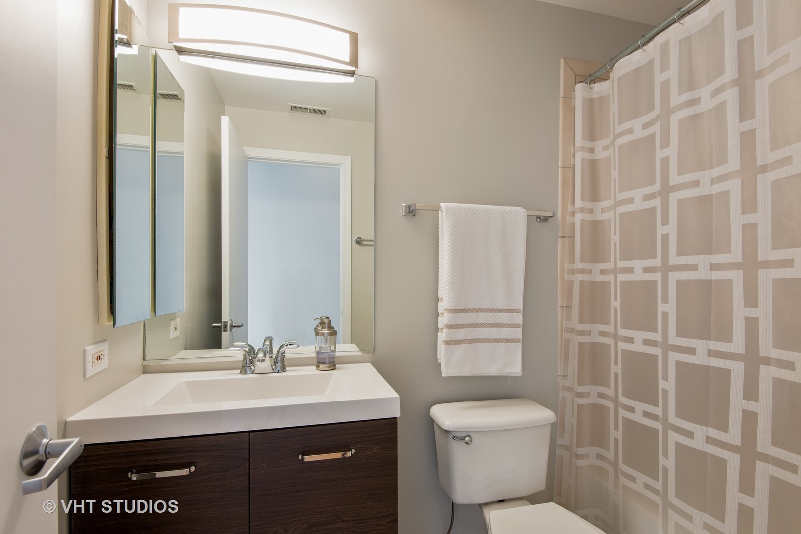 1834 Ridge Avenue, Unit 128 Evanston, IL 60201 - Photo 8 of 9 a bathroom with a granite countertop toilet sink shower and mirror