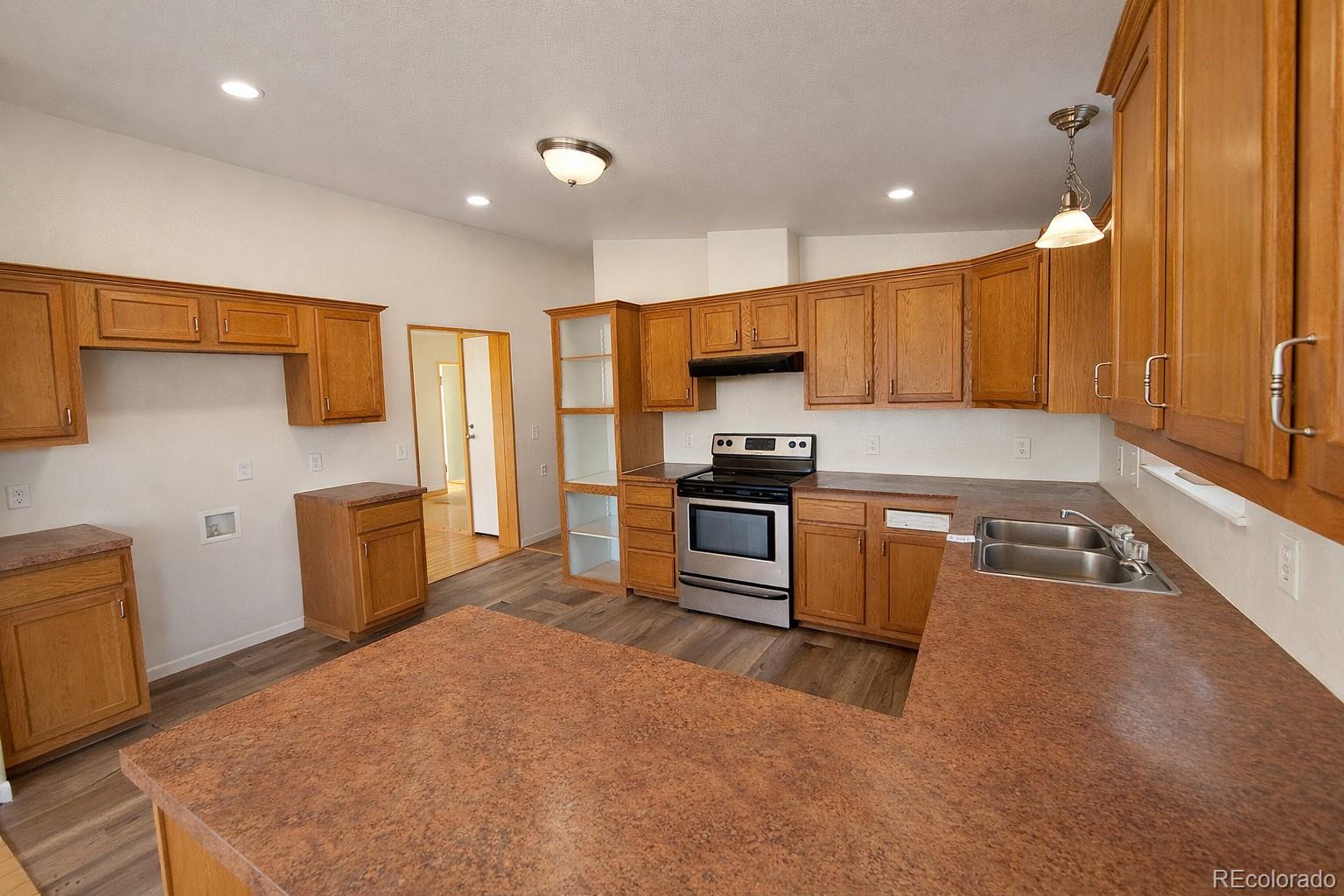 577 Fdr 101 Road Antonito, CO 81120 - Photo 12 of 40 a kitchen with a refrigerator and a stove top oven