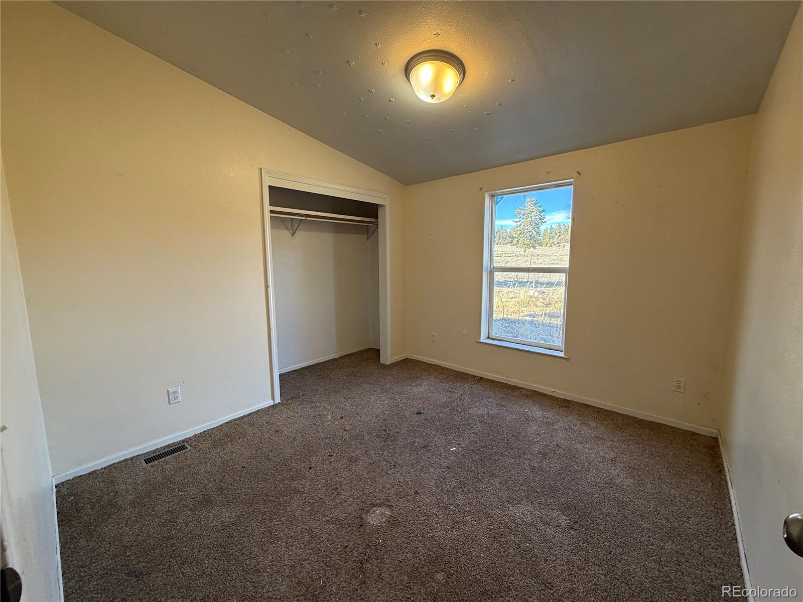 577 Fdr 101 Road Antonito, CO 81120 - Photo 19 of 40 an empty room with windows and closet