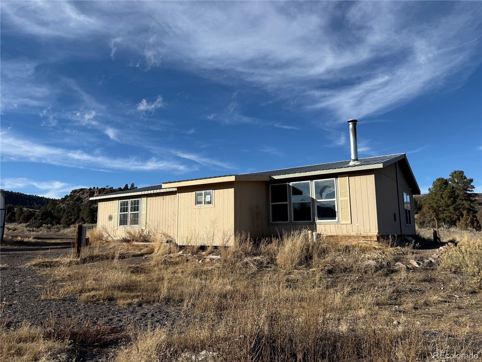 577 Fdr 101 Road Antonito, CO 81120 - Photo 2 of 40 a view of a house with backyard and sitting area