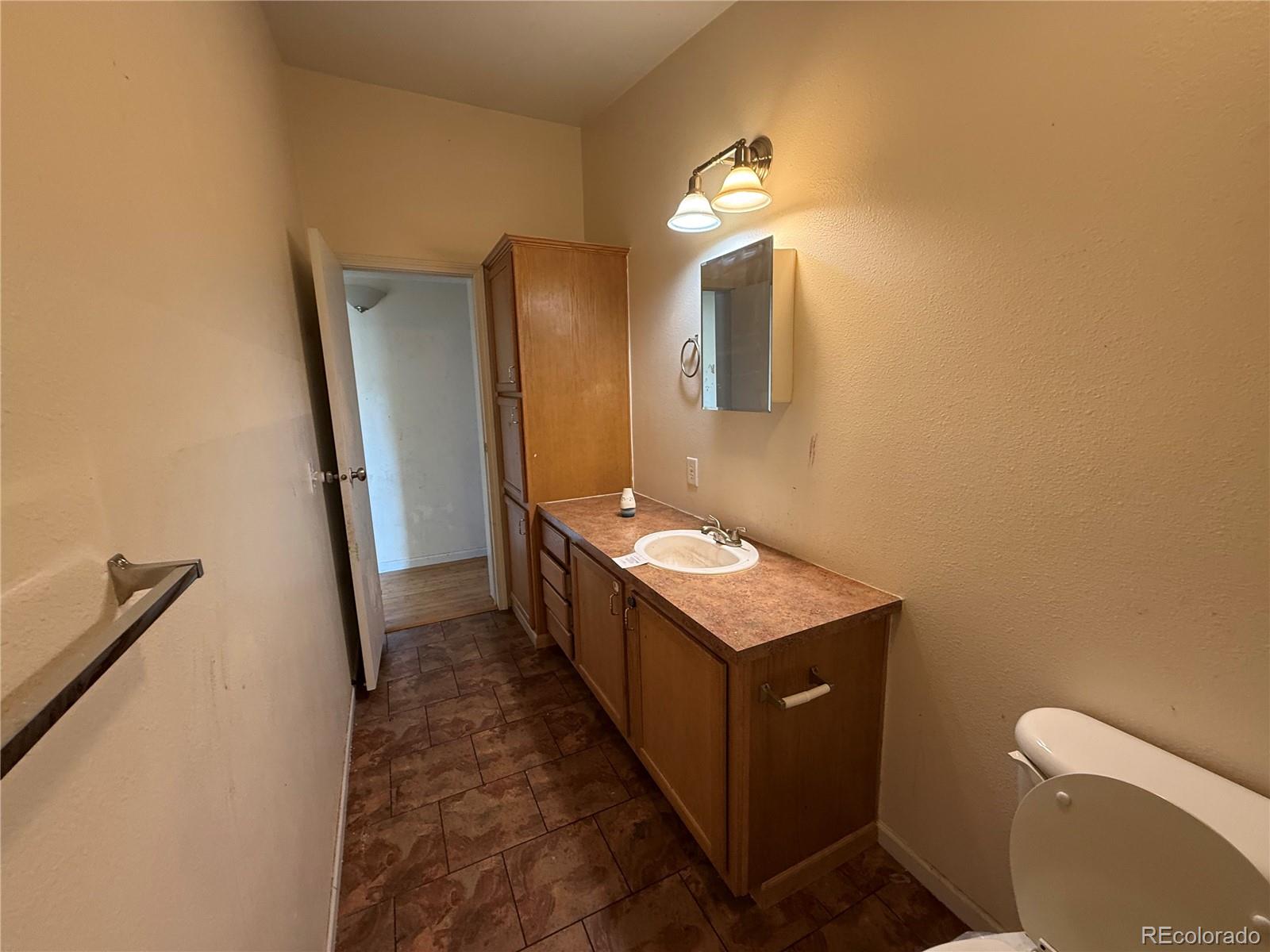 577 Fdr 101 Road Antonito, CO 81120 - Photo 21 of 40 a bathroom with a sink a toilet and mirror