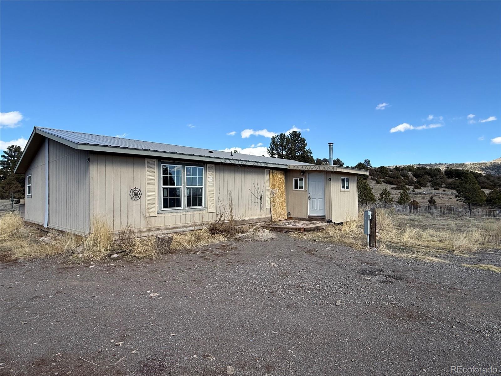 577 Fdr 101 Road Antonito, CO 81120 - Photo 33 of 40 a view of a house with a backyard