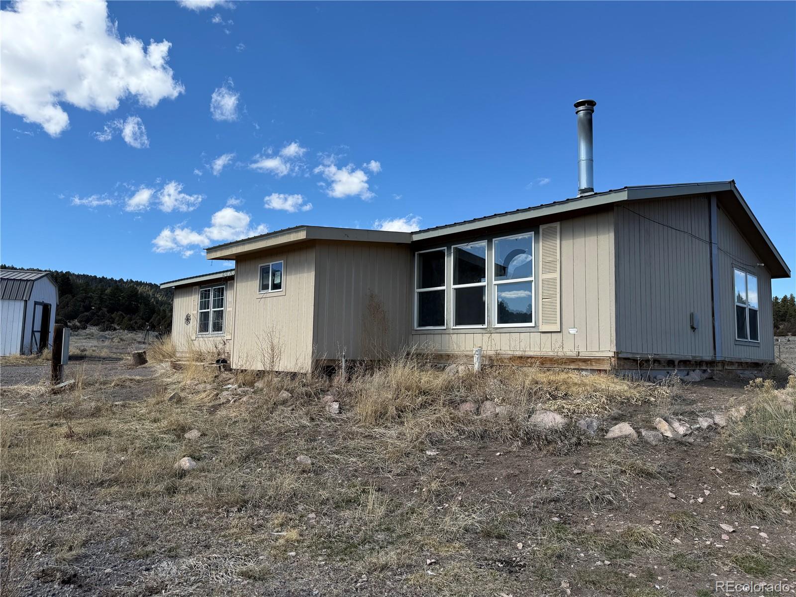 577 Fdr 101 Road Antonito, CO 81120 - Photo 34 of 40 a house view with a backyard space