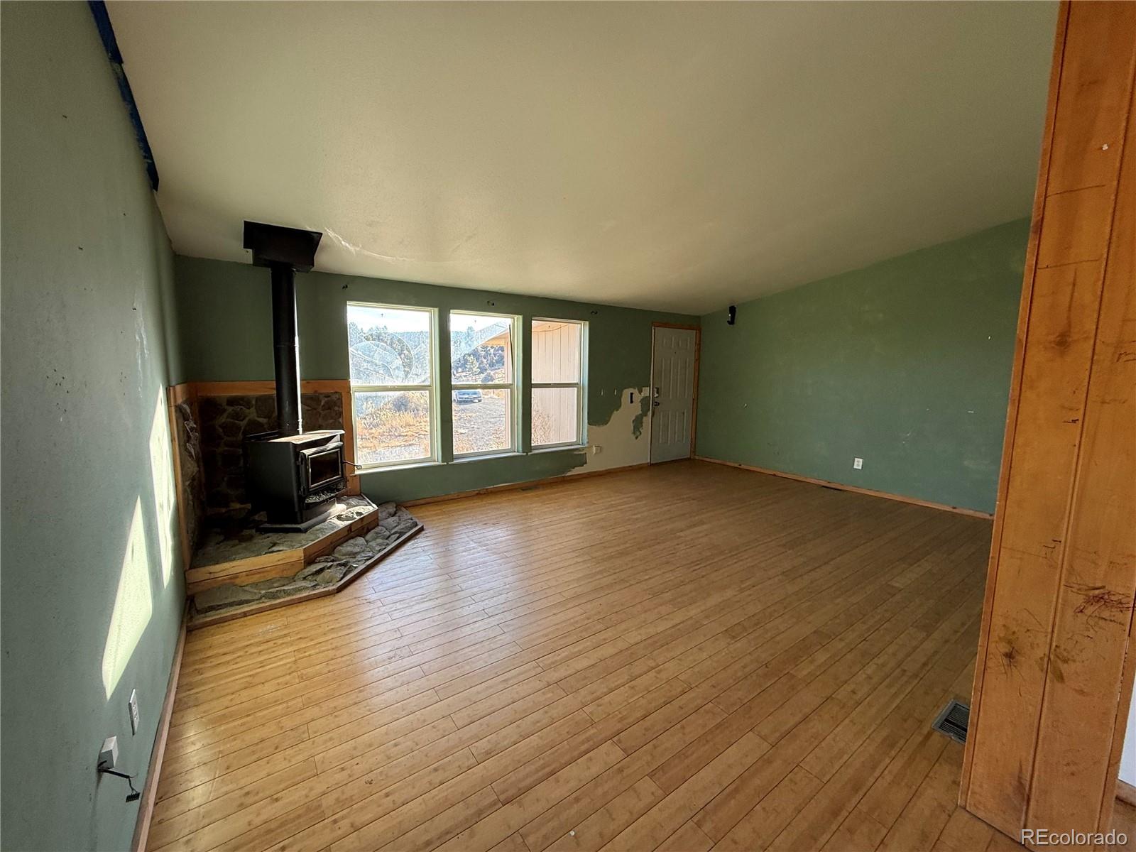 577 Fdr 101 Road Antonito, CO 81120 - Photo 10 of 40 wooden floor and windows in an empty room