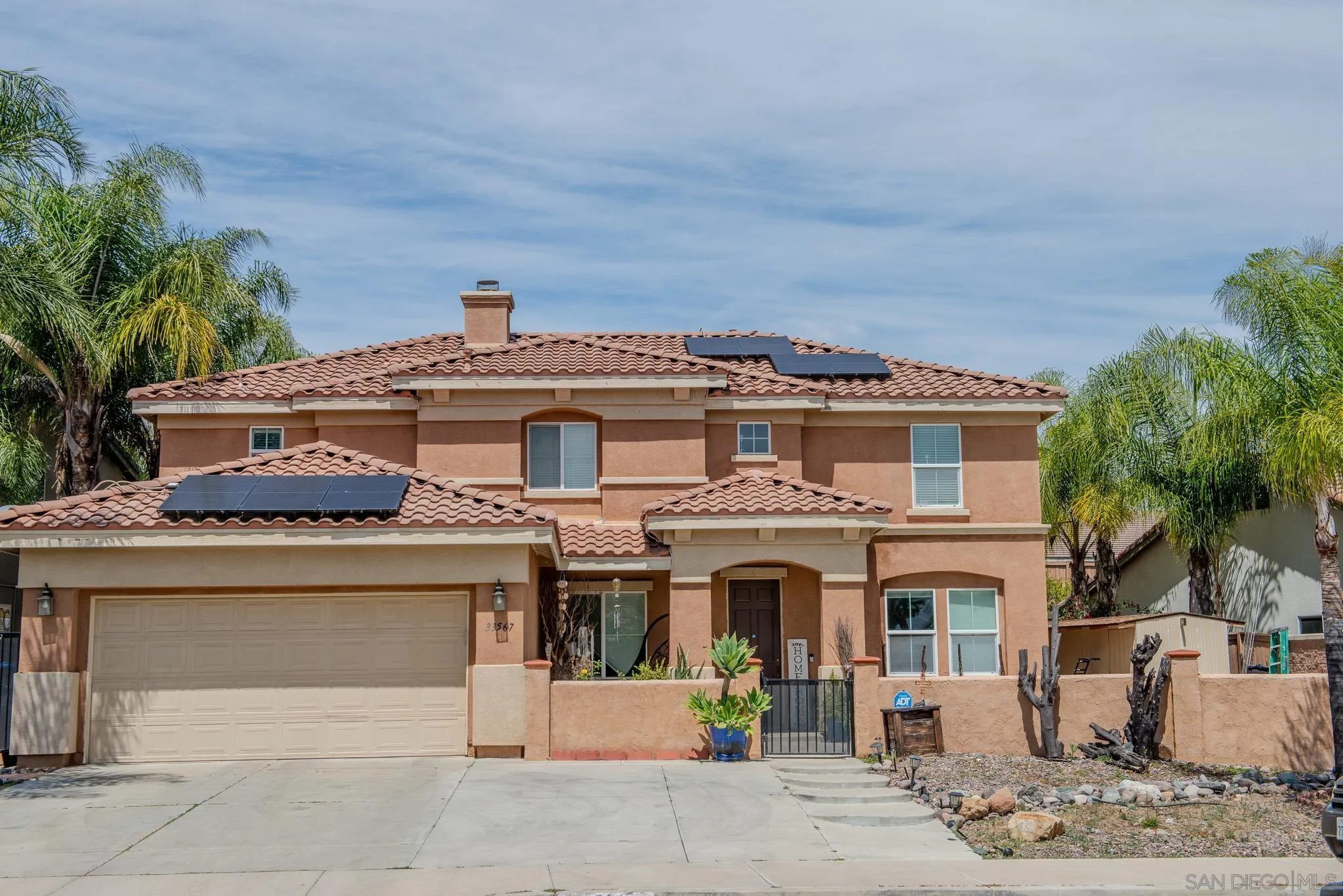 33567 Magnetite Street Menifee, CA 92584 - Photo 1 of 49 a view of a white house with large windows and a table and chairs