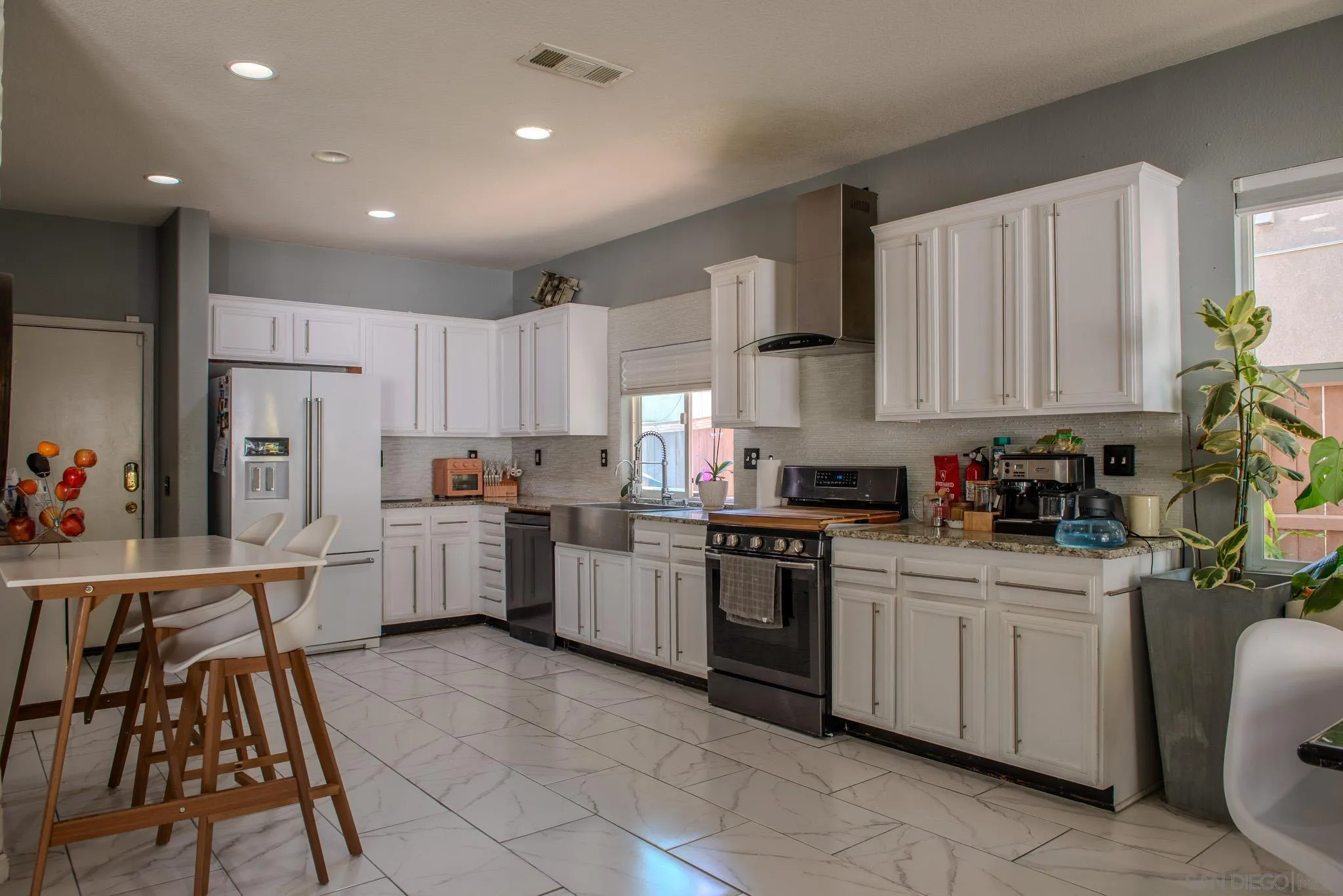 33567 Magnetite Street Menifee, CA 92584 - Photo 18 of 49 a kitchen with white cabinets stainless steel appliances and sink